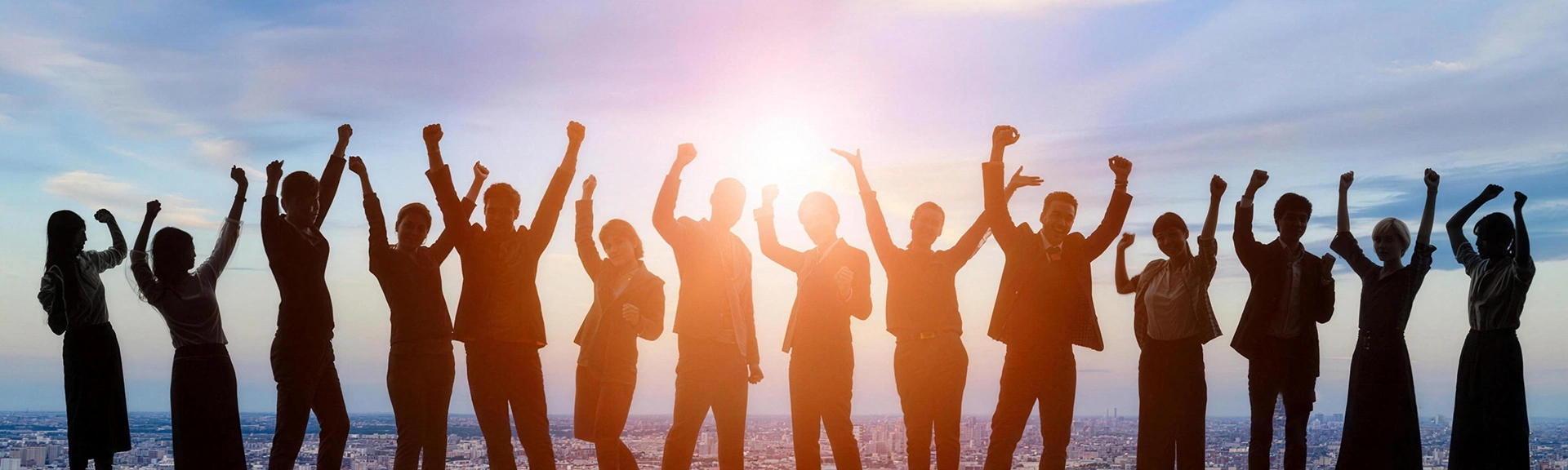 A backlit company team standing together