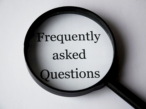 FAQ magnified under a magnifying glass